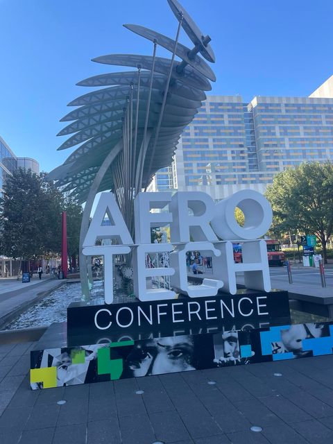 AftoTech sign and canoe statue